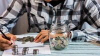 Photo jar with savings coins on table. Image by Freepik Photo jar with savings coins on table. Image by Freepik